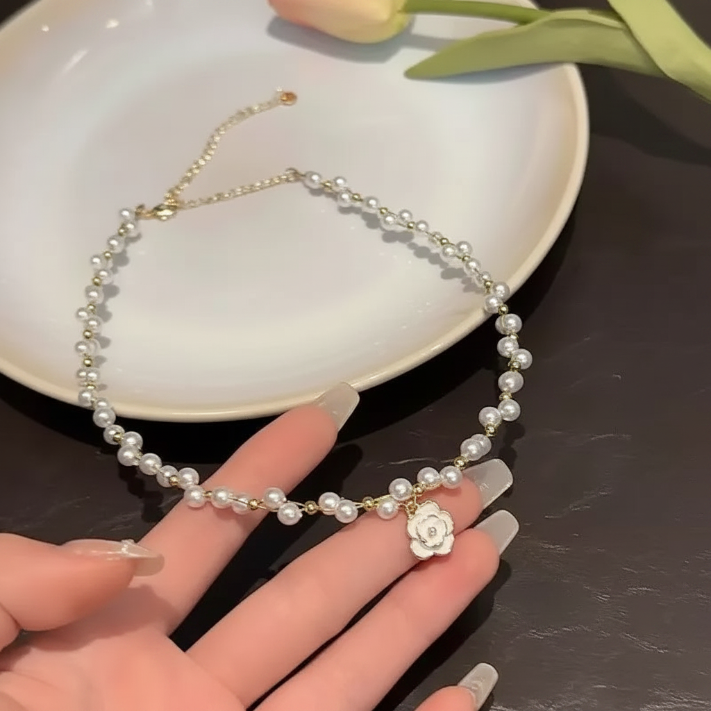 Camellia pearl necklace held in hand