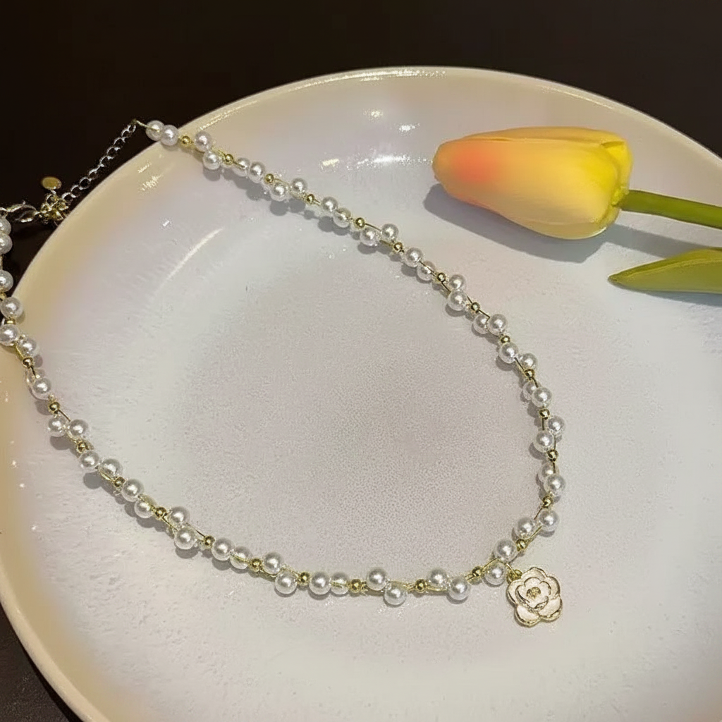 Camellia pearl necklace on white plate with tulip