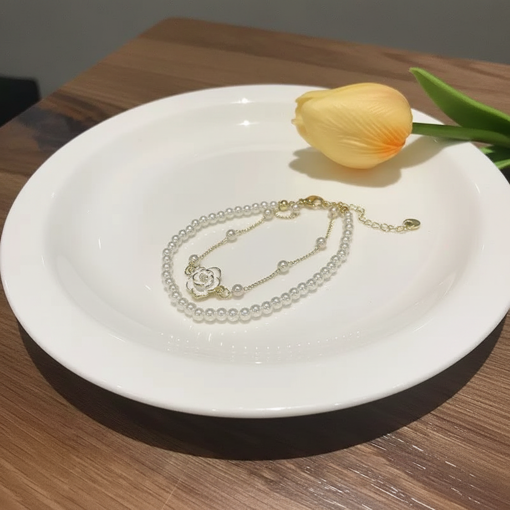 Camellia pearl bracelet on white plate with tulip